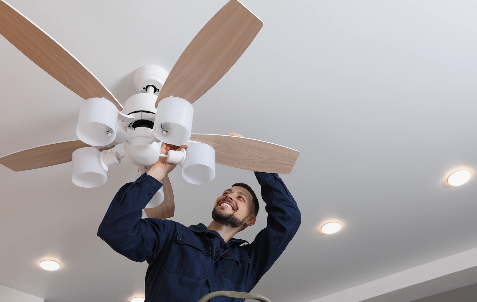 Licensed electrical contractor Phoenix service working on ceiling fan